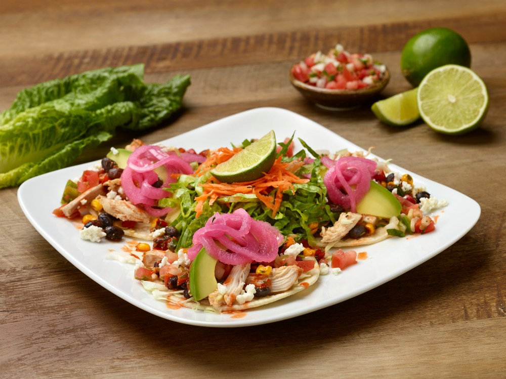 SMOKED CHICKEN TACOS (550 CAL) Pulled chicken, cabbage, avocado, corn & black bean salsa, pico de gallo, cotija cheese and pickled red onions on corn tortillas. served with fresh greens.